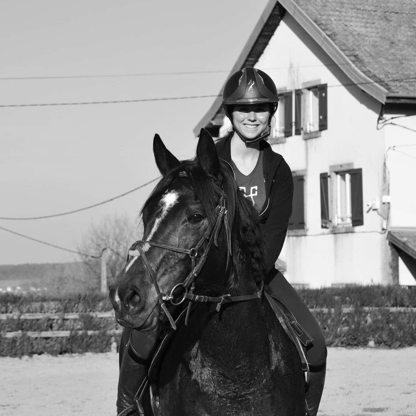 Laura Jardon smiling on horseback in the yard’s arena
