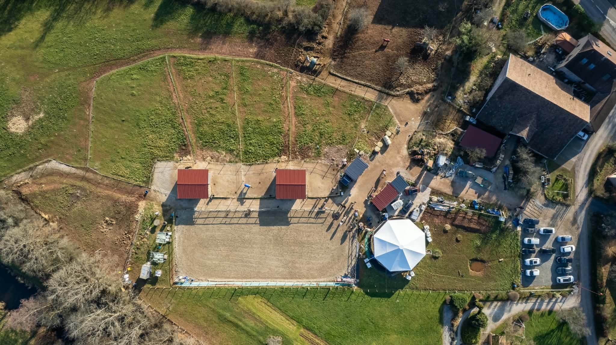 Aerial view of Écurie de la Lizaine: arena, shelters, paddocks and fields in Frahier-et-Châtebier